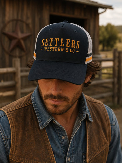 Navy blue Settlers Western & Co trucker cap with golden embroidered wordmark and white mesh back