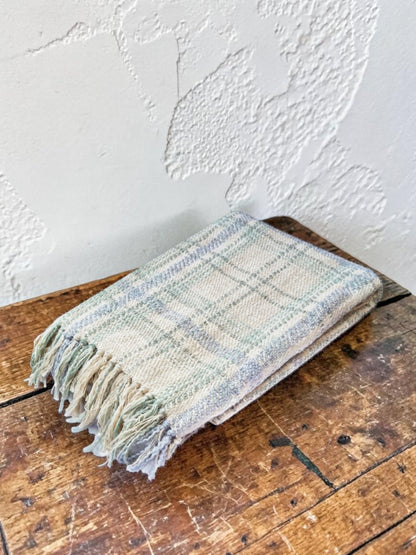 "Green Pastures" woven throw blanket in sage green, folded