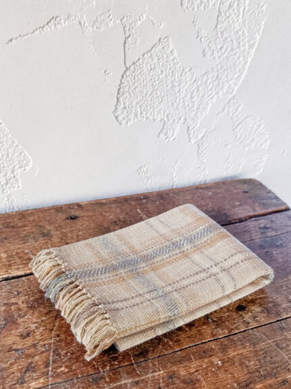 "Dusty Plains" woven throw blanket in dusty pink, folded